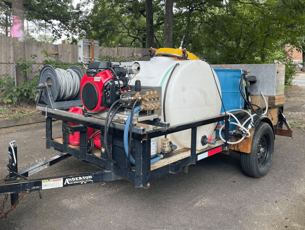 Metro Wash ATL trailer-mounted pressure washing rig with Honda engine, water tank, and hose reel